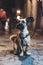 Portrait smiles brown pet, funny dog â€‹â€‹sits on a bokeh background of the night city on a leash outdoor, home puppy enjoy