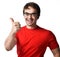 Portrait of smiling adult man in glasses and red t-shirt gesturing thumbs up sign over white background. Expressing