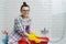 Portrait of smiling adult woman in glasses, rubber gloves doing house cleaning, female cleaning bathroom