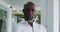 Portrait of smiling african american businessman in white shirt standing in office