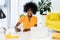 portrait of smiling african american freelancer at workplace with laptop and notebook