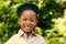 Portrait of smiling african american scout girl in uniform at forest