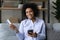 Portrait of smiling African American woman shop on cell