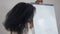 Portrait of smiling African American woman standing at whiteboard with Financial education words smiling looking at