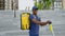 Portrait smiling afro-american man courier with backpack and electric scooter