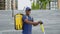 Portrait smiling afro-american man courier with backpack and electric scooter