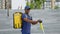 Portrait smiling afro-american man courier with backpack and electric scooter