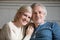 Portrait of smiling aged couple making family picture