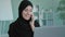 Portrait smiling Arabian Muslim Islamic business woman in black hijab professional smiling happy conversation talking on