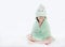 Portrait of smiling Asian child girl after bath covered head and eyes with towel. Funny kid in towel sitting on white background
