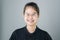 Portrait of smiling asian young women put on the braces. on a gray background gives a soft light.