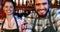 Portrait of smiling barmaid and barman at bar counter