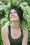 Portrait of a smiling beautiful girl in wreath flowers and herbs on the meadow sunny day. young Slavic woman