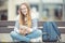 Portrait of a smiling beautiful teenage girl with dental braces. Young schoolgirl with school bag and tablet device