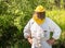 Portrait of smiling Beekeeper with beekeeping hat and veil