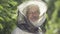 Portrait of smiling beekeeper in the garden