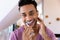 Portrait of smiling biracial man brushing teeth in bathroom