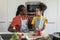 Portrait Of Smiling Black Dad And Daughter Preparing Food In Kitchen Interior