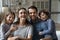 Portrait of smiling bonding parents and little children posing at home.