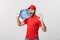 Portrait smiling bottled water delivery courier in red t-shirt and cap carrying tank of fresh drink and showing ok