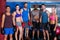 Portrait of smiling boxers with coach in gym