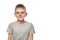 Portrait of a smiling boy in a gray t-shirt. Schoolboy. White background, place for text