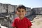 Portrait of smiling boy in the temple of Apollo.