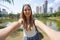 Portrait of smiling Brazilian girl takes selfie in Vaca Brava Park in Goiania, Goias, Brazil