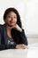 Portrait of smiling businesswoman with dreadlocks, head and shoulders