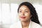 Portrait of smiling businesswoman with dreadlocks, head and shoulders