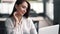 Portrait of smiling businesswoman sits in cafe, works on laptop, slow motion