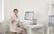 Portrait of a smiling businesswoman sitting in front of a computer at her workplace in the office.