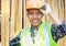 Portrait of a smiling carpenter holding wood