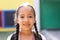 Portrait of smiling cauasian elementary schoolgirl in school playground, copy space