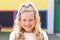 Portrait of smiling cauasian elementary schoolgirl in school playground, copy space