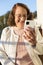 Portrait of smiling Caucasian older woman making a video call through mobile phone