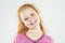 Portrait of Smiling Caucasian Redhaired Little Girl.Standing Against White