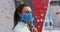 Portrait of smiling caucasian woman adjusting face mask at an indoor climbing gym