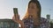 Portrait of smiling caucasian woman taking selfie at a skatepark