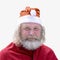 Portrait of a smiling charismatic senior man with a beard dressed as Santa Claus