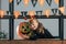 portrait of smiling child in halloween costume at carved pumpkin and hanging flags