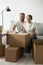 Portrait of smiling couple sitting together at couch, preparing