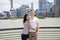 Portrait of smiling couple standing by railing with Shanghai skyline in background