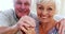 Portrait of smiling couple with walking stick in living room