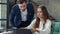 Portrait of smiling coworkers looking on laptop screen on workplace. Office work