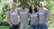 Portrait of smiling, diverse group of happy friends in volunteer t shirts embracing outdoors