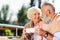 portrait of smiling elderly couple with cups of coffee looking