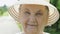 Portrait of smiling elderly woman dressed in hat