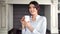 Portrait of smiling elegant housewife woman enjoying break holding white mug looking at camera