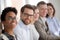 Portrait of smiling employees sit in row looking at camera